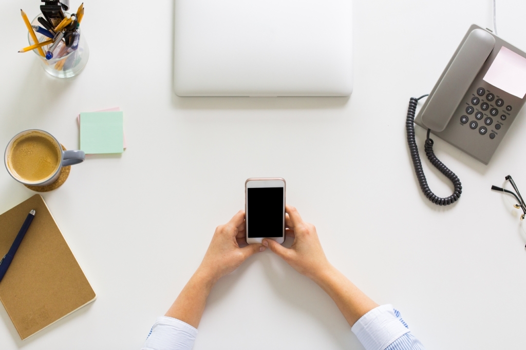 businesswoman with smartphone working at office